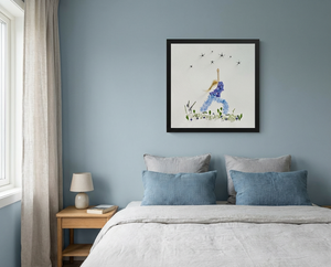Blue Petal Balance botanical wall art in a black frame, hung in a calm blue bedroom with light wood furniture, a japandi-style setting.