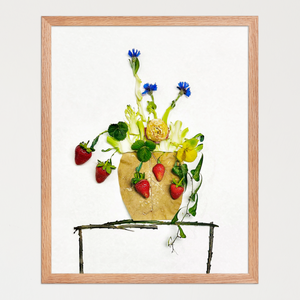 Vase-like form of leaves, stems, red strawberries, and small blue flowers on a simple table. Botanical wall art by FloraFusion.