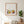 Meadow Garden botanical wall art print in a red oak frame, shown in a calm neutral room