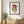 Heart in Bloom botanical wall art print in a black frame, shown in a calm neutral room