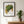 Golden Leaf botanical wall art print in a black frame, shown in a calm neutral room