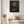 Autumn Lady print in a black frame hanging in a living room