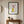 Banana Bloom print in a black frame styled in an entryway. FloraFusion.