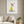 Banana Bloom print in a white frame styled in a living room. FloraFusion.