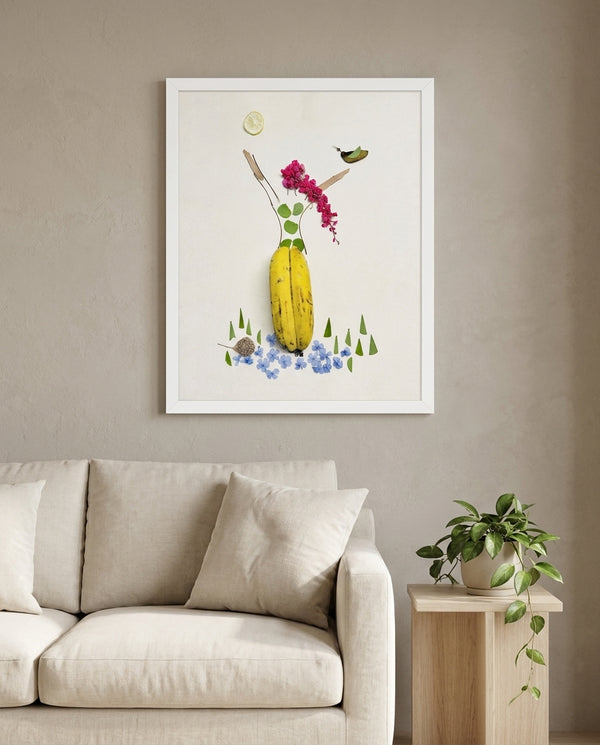 Banana Bloom print in a white frame styled in a living room. FloraFusion.