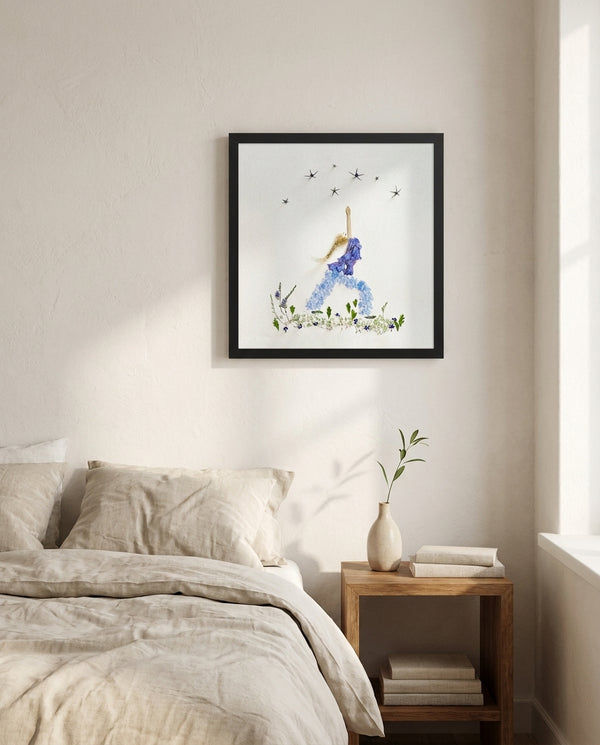 Blue Petal Balance print in a black frame hanging in a bedroom