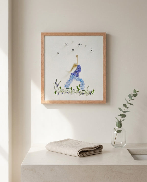 Blue Petal Balance print in a red oak wood frame hanging in a bathroom