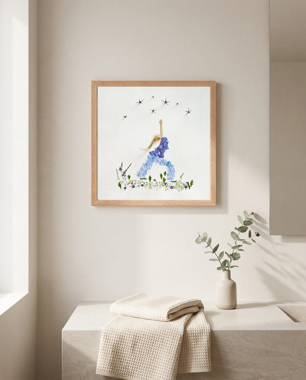 Blue Petal Balance print in a red oak wood frame hanging in a bathroom