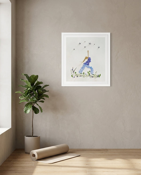 Blue Petal Balance print in a white frame hanging in a yoga studio
