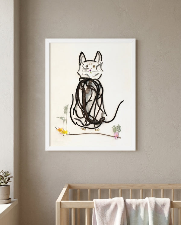 Botanical Cat Portrait art in a white frame hanging in a nursery