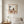 Braided by Nature in a red oak frame styled in a bedroom. FloraFusion botanical wall art.