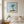 Breezy Island Moment in a red oak frame styled in a bedroom. FloraFusion botanical wall art.
