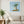 Breezy Island Moment in a white frame hanging in a serene living room. FloraFusion botanical wall art.