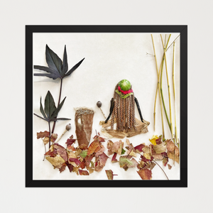 Seated feminine figure with braided grass hair and layered bark, seed pods, and plant fibers on white. Botanical wall art by FloraFusion.