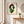 The Celery Woman print in a red oak wood frame hanging in an entryway