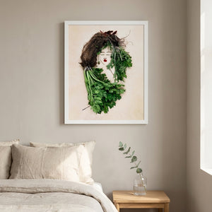 The Celery Woman print in a white frame hanging in a bedroom