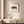 Chameleon in Bloom art in a red oak frame hanging in a bathroom