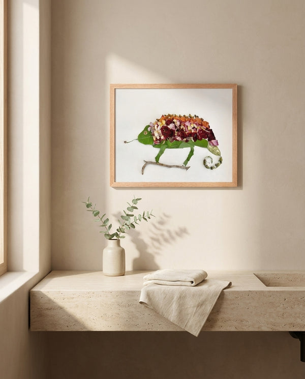 Chameleon in Bloom art in a red oak frame hanging in a bathroom