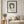 Chamomile Grace botanical feminine wall art print in a black frame hanging in a living room
