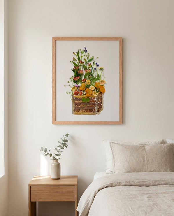 Cottage Flower Crate wildflower still life wall art print in a red oak wood frame hanging in a bedroom