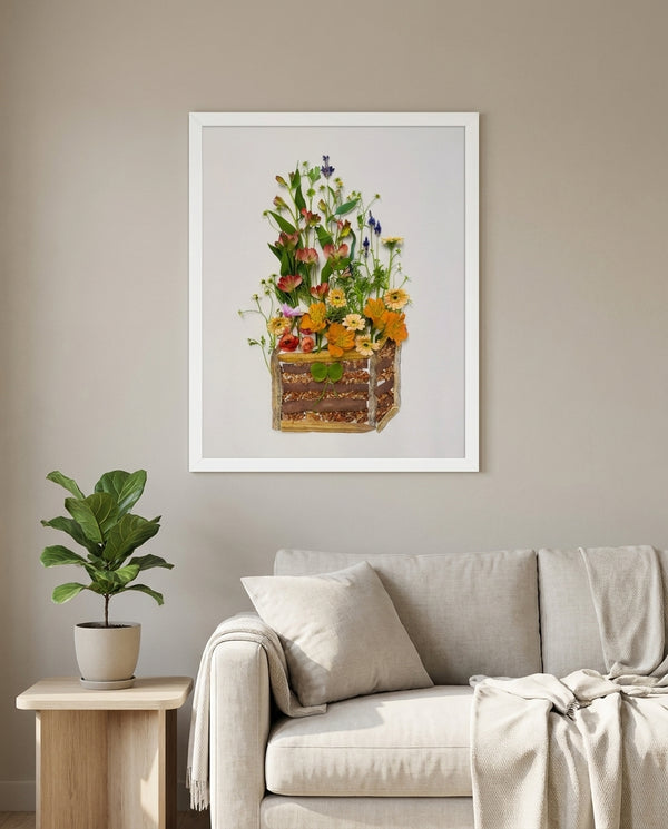Cottage Flower Crate wildflower still life wall art print in a white frame hanging in a living room