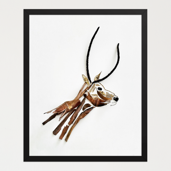 Gazelle in thoughtful repose shaped from layered leaves and bark tones on a white background. Botanical wall art by FloraFusion.