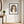 Earthbound Lady in a black frame styled in an entryway. FloraFusion botanical wall art.