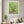 First Blossoms botanical spring tree wall art print in a white frame hanging in a living room
