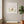 Forward in Bloom in a white frame hung in a serene yoga studio