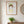 Garden Crown Lady art print in a red oak frame in a warm entryway