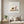 Garden Day Journey art print in a white frame in a modern living room