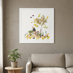 Garden Tender in a white frame above a linen sofa in a calm living room