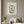 Garden Window Home art in a white frame hanging in a living room