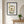 Garden Window Home art in a black frame hanging in an entryway