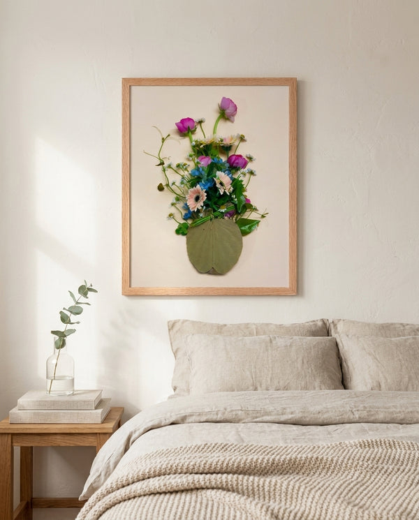 Gathered Bouquet floral still life wall art print in a red oak wood frame hanging in a bedroom