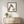 Gentle Giraffe in a black frame in a playful kids room with light wood furniture