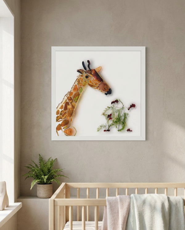 Gentle Giraffe in a white frame above a crib in a soft nursery