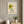 Girl in Bloom whimsical floral girl wall art print in a white frame hanging in a living room