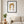 Golden Dates Portrait art in a black frame hanging in a living room