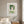 Green Fringe Lady botanical feminine portrait wall art print in a white frame hanging in a bedroom