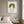 Green Meadow Lady in a white frame above a bed in a restful bedroom