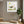 Grounded in Light art in a white frame hung in a serene yoga studio