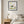 Grounded in Light art in a black frame hung in a bedroom