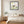 Grounded in Light art in a black frame hung in a bedroom