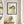 Hanging in Nature in a black frame in a serene entryway with a round mirror