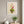 Happy Little Vase whimsical floral still life wall art print in a white frame hanging in a living room