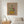 Lily Row botanical lily still life wall art print in a red oak wood frame hanging in a bedroom