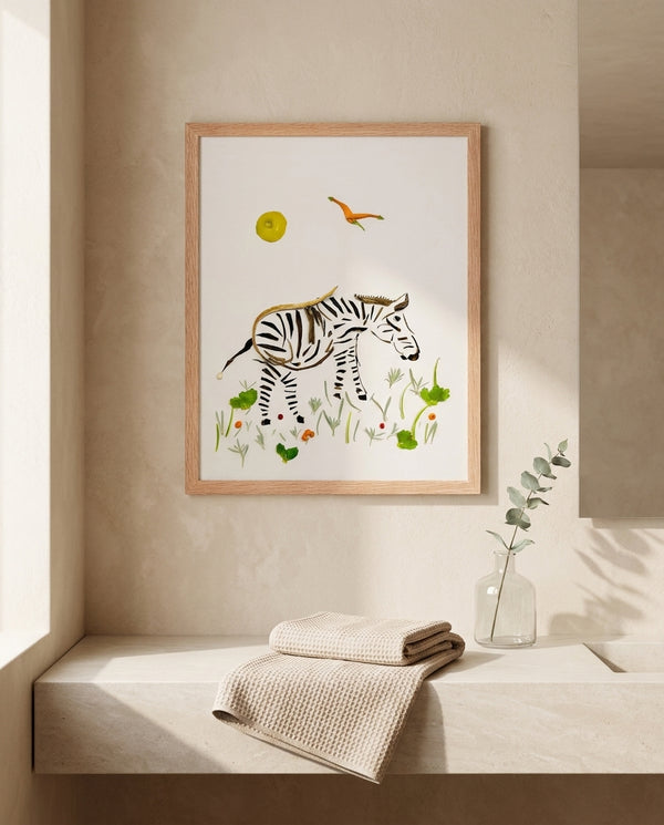 Little Grazing Zebra botanical animal wall art print in a red oak wood frame hanging in a bathroom