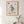 Looking Back Zebra botanical wildlife wall art print in a red oak wood frame hanging in a bathroom