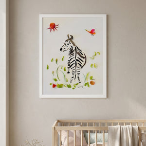 Looking Back Zebra botanical wildlife wall art print in a white frame hanging in a nursery